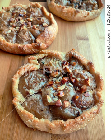 freshly baked apple galette with mascarpone and almonds on golden crust straight from the oven 125285624