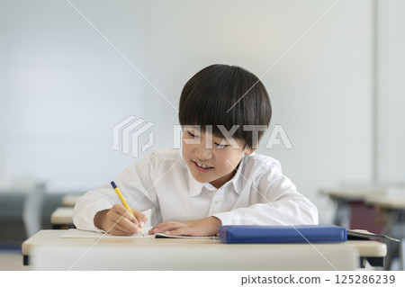 A fourth grade boy studying A fourth grade boy studying 125286239