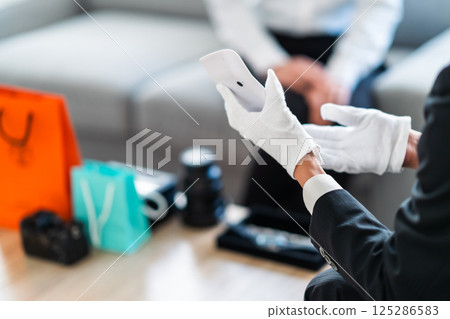 Businessman and housewife making price proposals, no faces Businessman and housewife making price proposals, no faces 125286583