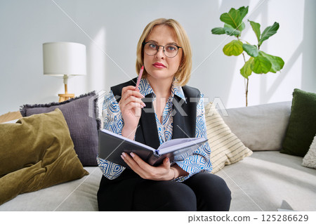 Webcam view middle aged businesswoman looking talking in camera Webcam view middle aged businesswoman looking talking in camera 125286629