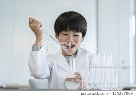 A fourth grade boy doing a science experiment 125287009