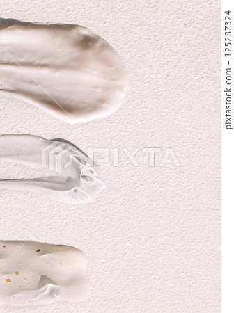 Different texture of gel and cream on a light background. Transparent serum with bubbles and colloidal gold. The consistency of glycerin gel. Various cosmetic cream smears. Different texture of gel and cream on a light background. Transparent serum with bubbles and colloidal gold. The consistency of glycerin gel. Various cosmetic cream smears. 125287324