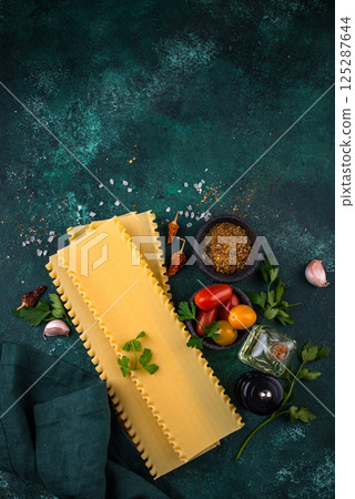 Uncooked lasagna pasta with cooking ingredient 125287644