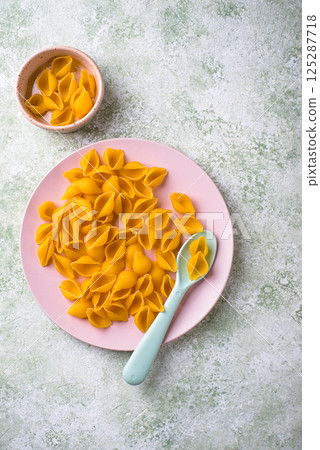 Raw pasta in shape of shells 125287718