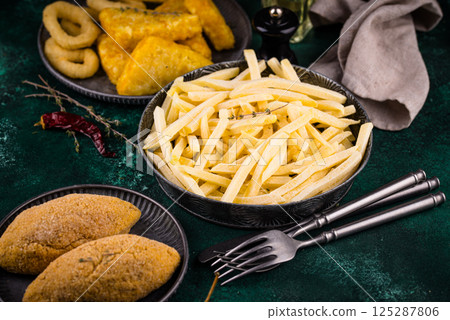 Frozen food assortment. Potato hashbrowns and french fries 125287806