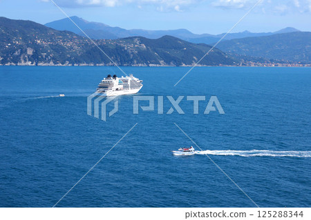 Tourist cruise liner in bay of Porto Venere, Liguria. Sea and holidays in Italy. Background for design. 125288344