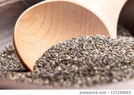 Organic chia seeds and wooden spoon. Macro shot 125289083