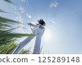 Charming Korean woman against blue sky with clouds. Freedom 125289148
