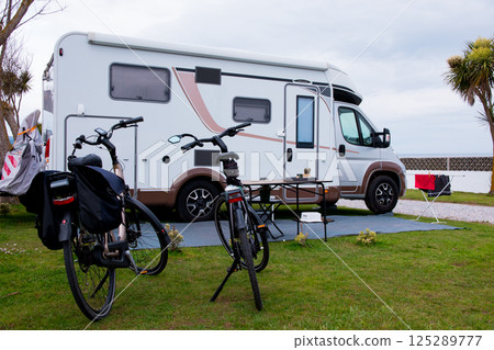 Cozy motorhome parked with bicycles in scenic outdoor setting 125289777