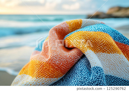 Beach towel with bold geometric patterns in summer beach. Retro style. Close-up. 125290762