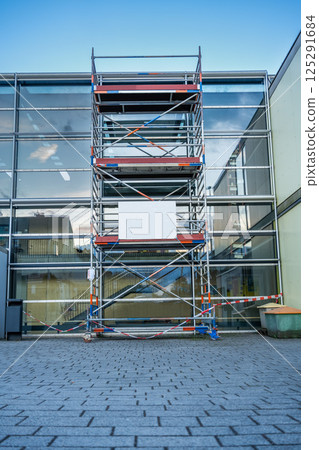 scaffolding near the facade glass wall, mockup 125291684