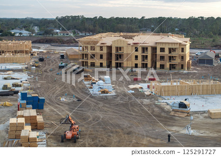 Wooden apartment buildings under construction in new developing suburban area. Development of residential housing in Florida suburbs. Real estate market in the USA 125291727