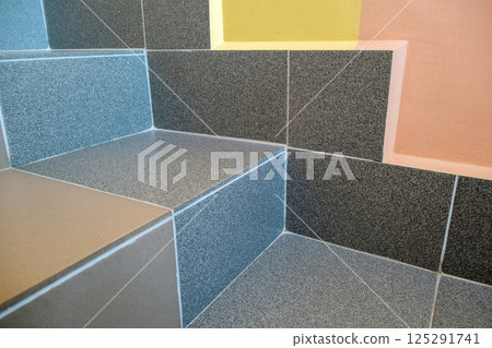Wide staicase covered with ceramic tiles indoors in a house interior. Wide staicase covered with ceramic tiles indoors in a house interior. 125291741