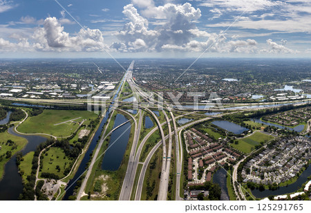 View from above of USA transportation infrastructure. American freeway intersection with fast driving cars and trucks in Miami, Florida 125291765