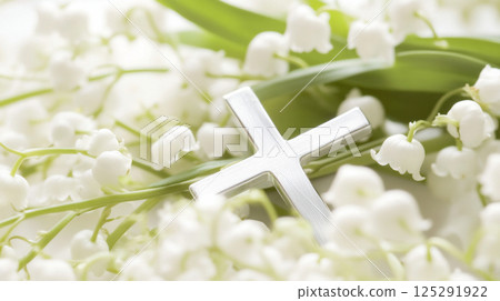 Silver cross on lily of the valley flowers with wooden background 125291922