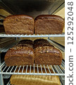 Freshly baked bread on trolley in bakery 125292048