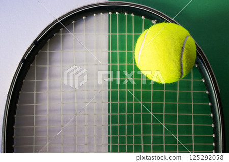 Tennis ball on racket. White and green background. Concept of sports competitions 125292058