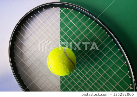 Raket and tennis ball on white and green background. Concept of sports competitions 125292060