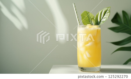 Cold pineapple juice in a glass with leaves Cold pineapple juice in a glass with leaves 125292270