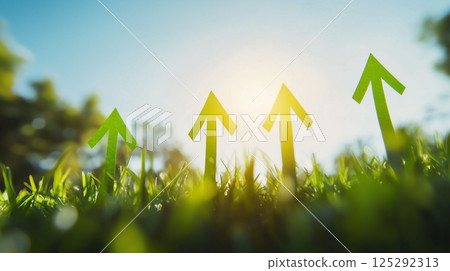 Green grass field shows upward arrows made of grass. 125292313