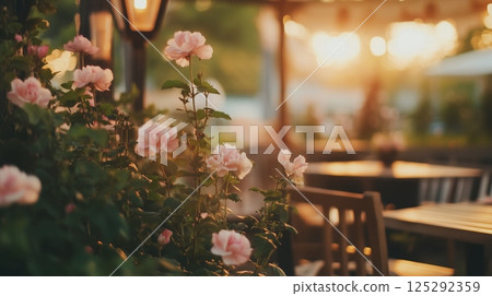 Outdoor garden cafe at summer evening. Wooden tables 125292359