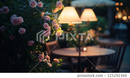Outdoor garden cafe at summer evening. Wooden tables 125292360