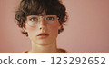 Portrait of a guy with glasses on a studio background. Vision correction with modern technologies. 125292652