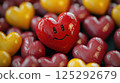 Sad upset heart-shaped smiley face among a variety of colored hearts. The broken heart of love 125292679