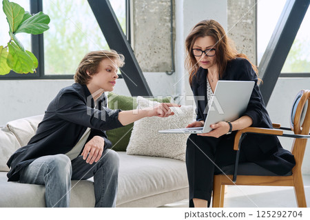 Teenage guy high school student meeting with psychologist, counselor Teenage guy high school student meeting with psychologist, counselor 125292704