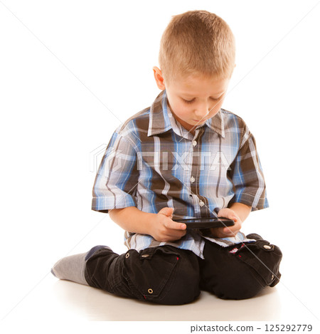 Little boy playing games on smartphone 125292779