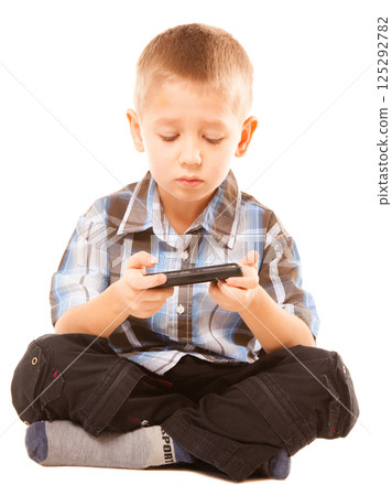 Little boy playing games on smartphone 125292782