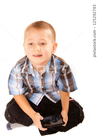 Little boy playing games on smartphone 125292783