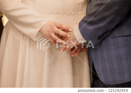 Intimate Wedding Moment: A Close-Up of Hands During a Loving Exchange 125292959