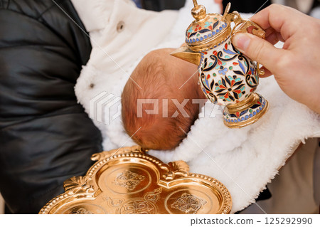 Traditional Baby Baptism Ceremony with Ornate Metalware Traditional Baby Baptism Ceremony with Ornate Metalware 125292990