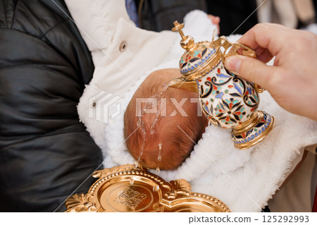 Traditional Baptism of an Infant with Ornate Water Vessel and Golden Plate Traditional Baptism of an Infant with Ornate Water Vessel and Golden Plate 125292993