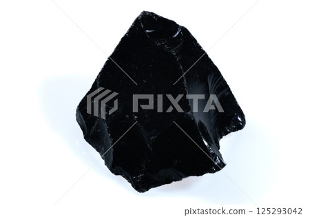 Shiny Black Natural Obsidian Stone Fragment with Sharp Edges on White Background 125293042