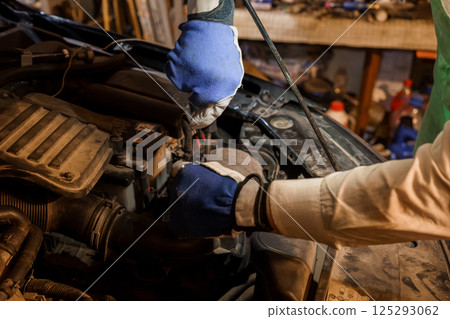 Car Maintenance Technician Working Under the Hood 125293062