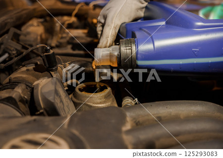 Car Maintenance: Adding Engine Oil to a Vehicle Car Maintenance: Adding Engine Oil to a Vehicle 125293083