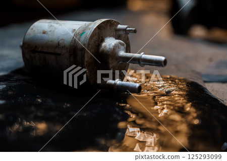 Rusted Fuel Pump Leaking Oil in Dark Garage Setting 125293099