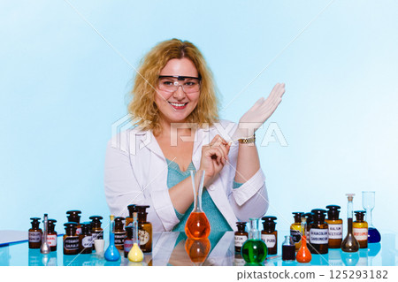 female chemistry student with glassware test flask. 125293182