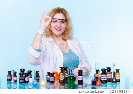 female chemistry student with glassware test flask. 125293184