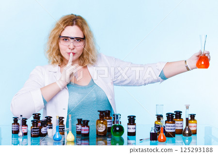 female chemistry student with glassware test flask. 125293188