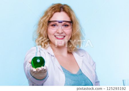 female chemistry student with glassware test flask. female chemistry student with glassware test flask. 125293192