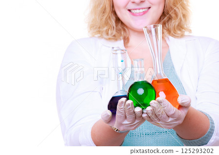 Chemist woman holds test flask 125293202