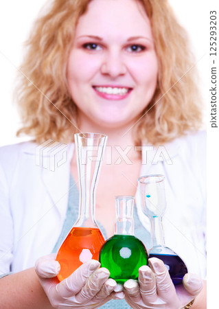 Chemist woman holds test flask Chemist woman holds test flask 125293203