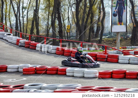 Excitement on the racing track while karting on a sunny afternoon 125293218