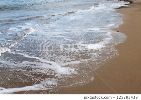 Sand beach and a line of the tide, Gran Canaria, Spain 125293439