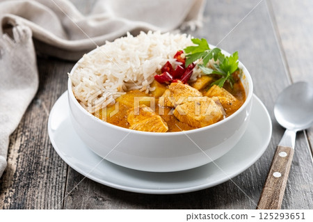 Massaman curry on wooden table. Traditional Thai food recipe Massaman curry on wooden table. Traditional Thai food recipe 125293651