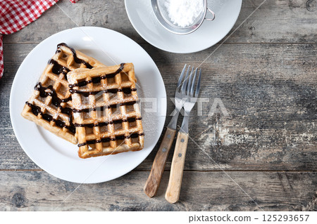 Belgian Waffles with chocolate on wooden table Belgian Waffles with chocolate on wooden table 125293657