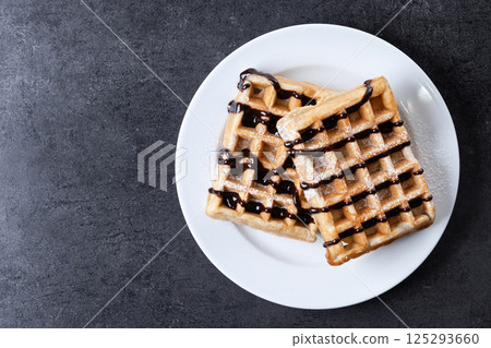 Belgian Waffles with chocolate on black slate background 125293660